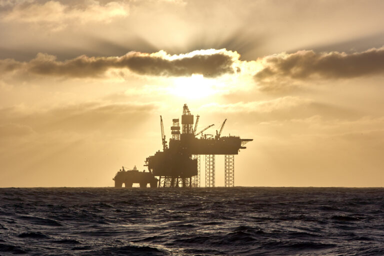 Silhouette of a jack up drilling rig in the North Sea at sunset. North sea offshore platform for oil and gas.